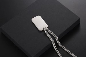 Polished silver stainless steel military dog tag pendant on a sleek curb chain necklace