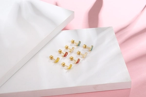 Detailed view of colorful striped titanium steel stud earrings set on a display