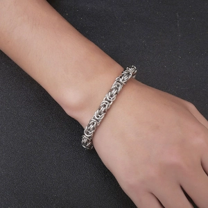 Men's vintage silver Byzantine woven stainless steel chain bracelet on wrist