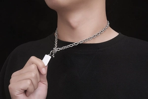 Detalle de cadena de acero de titanio plateado con cierre OT y colgante rectangular