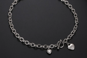 Detailopname van zilveren stalen ketting met toggle sluiting en LOVE hartvormige hanger
