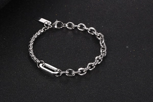 Detail eines silbernen Edelstahl-Gliederkettenarmbands mit Karabinerverschluss und Anhänger