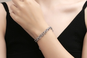Details eines silbernen Layering-Armbands mit grober O-Kette und feiner Kordelkette