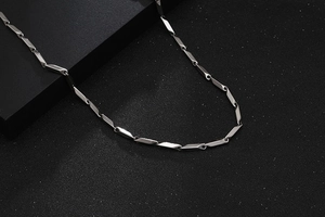 Detailed view of silver titanium steel necklace featuring geometric hexagonal link chain