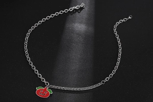Detailed macro view of punk style pumpkin pendant on mixed structure steel chain