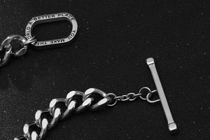 Macro detail of silver titanium steel OT buckle bracelet with inspirational engraving