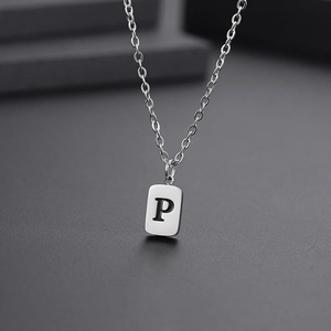 Detail of silver rectangle pendant featuring letter P on a fine stainless steel chain