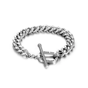 Polished silver Cuban link bracelet with engraved T-bar clasp for men on white background