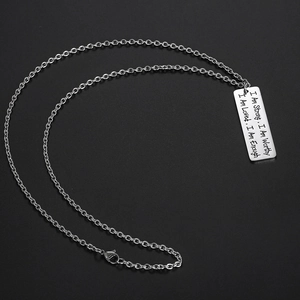 Collier en acier inoxydable avec texte inspirant gravé sur fond noir élégant