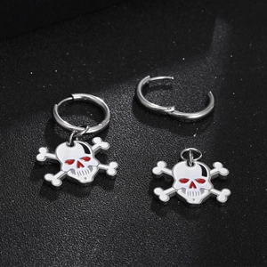 Gothic skull earrings with white enamel and red eyes on polished steel rings