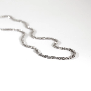 Fonkelende zilveren titanium stalen ketting met geweven textuur op witte achtergrond