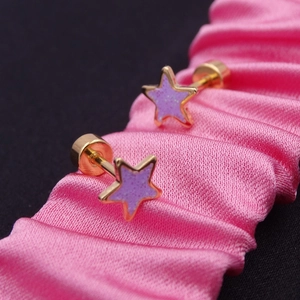 Macro shot of gold star studs with lilac glitter inlay and screw-back on pink silk