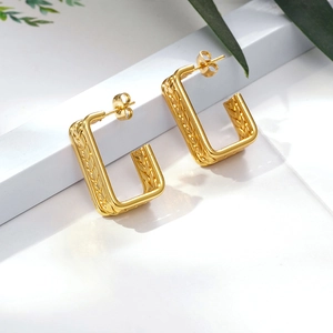 Elegant gold geometric U-shaped hoop earrings with intricate wheat pattern texture