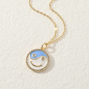 Gold necklace with blue and white yin-yang smiley face pendant and zircon crystal ring
