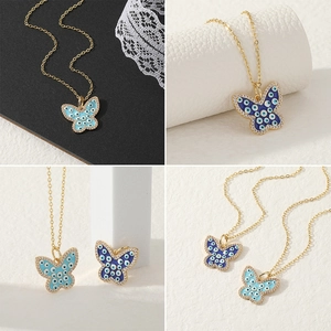 Boheemse vlinderketting met boze oog hanger, blauw emaille en kristallen in goudkleur