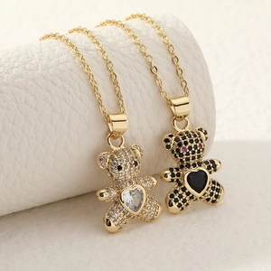 Matching gold-plated bear pendants with sparkling zircon inlay and heart stone