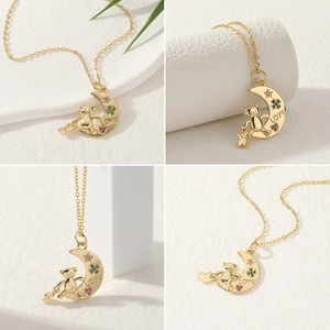 Detail shots of gold moon bear pendant with colorful zircon stones and LOVE engraving