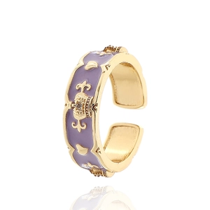 Detail eines lavendelfarbenen Emaille-Kronenrings mit goldenen Fleur-de-Lis Akzenten