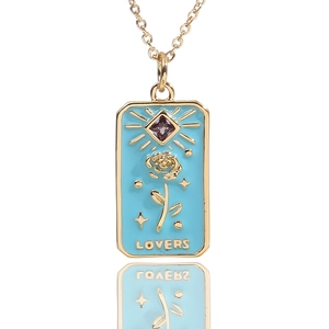 Detail of tarot-style lovers pendant with blue enamel, gold rose and purple zircon