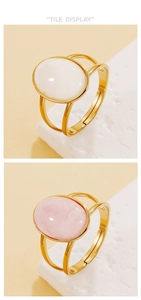 Detail view of adjustable vintage rings with white and pink resin stones on gold-plated metal