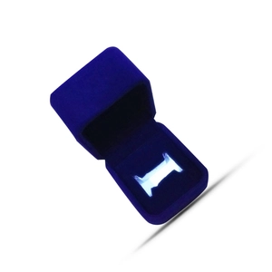 Detail of navy blue velvet jewelry box featuring a built-in LED light for ring display