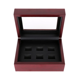 Macro view of mahogany wood jewelry box with glass top and six black leather slots