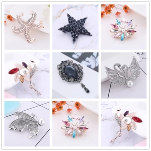 Detailed grid view showcasing crystal brooches with starfish, swan, and butterfly designs