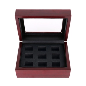 Top view of a 9-slot wooden sports ring display box with glass lid and black lining