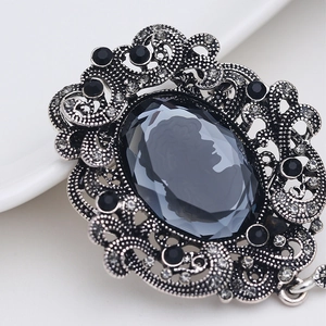 Vintage oval cameo brooch with crystal accents and antique silver floral frame