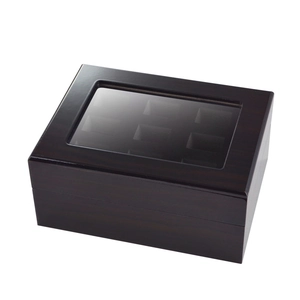 Close-up of walnut wood watch display box featuring six slots and clear glass window lid