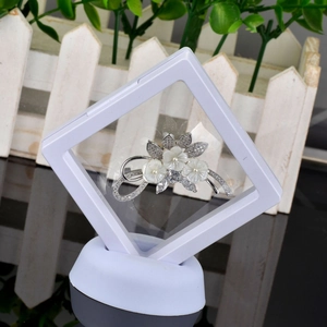 Detail of flower brooch with pearls and shells in a clear PE film suspension display case
