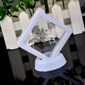 Silver flower brooch in a 3D floating display frame with white square PE film and base