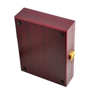 Close-up of mahogany finish golf ball display box base with anti-slip pads and gold latch
