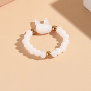 Detail of beaded rabbit ring featuring white multifaceted beads and a cute bunny charm