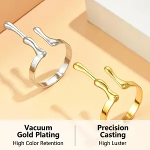 Detailed view of fluid-style adjustable rings featuring gold vacuum plating and high luster