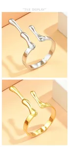 Detail display of minimalist irregular fluid antler rings in gold and silver finish