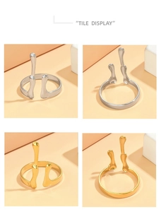 Detailed tile display of gold and silver antler style open rings on minimalist blocks