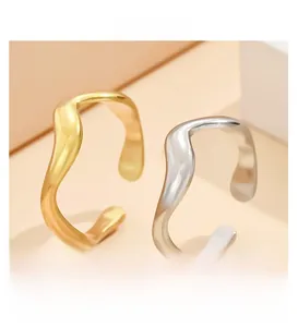 Detail von unregelmäßigen Wellenringen in Gold und Silber mit minimalistischem Design