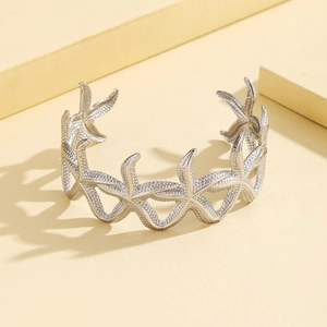 Silver adjustable starfish bangle with detailed textured star pattern in a marine design