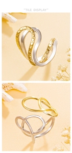 Detail view of two-tone gold and silver irregular streamline rings on sand background