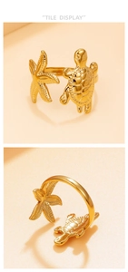 Detail display of an adjustable gold starfish and sea turtle ring with engraved textures