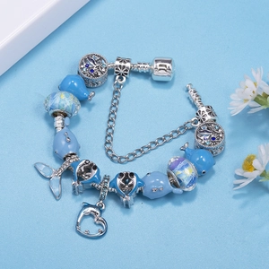 Ocean-themed silver charm bracelet with blue dolphins, fish tail and glass beads