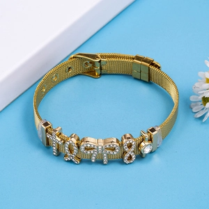 Golden mesh band bracelet with sparkling rhinestone charms on blue background