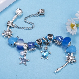 Silver snake chain bracelet with blue ocean charms featuring sea turtles and dolphins