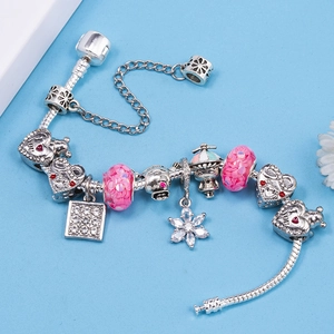 DIY silver charm bracelet with pink sequins, heart engraving and crystal floral pendants