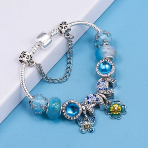 Blue butterfly charm bracelet with glass beads and crystals on silver snake chain