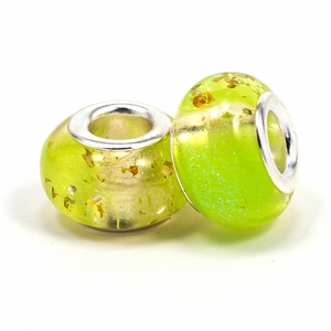 Detailed view of two green resin large hole beads with gold foil for DIY jewelry