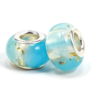 Macro detail of blue glass charm beads with gold leaf foil for DIY bracelets