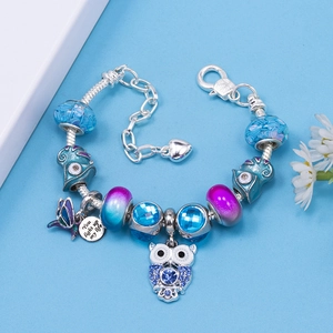 DIY charm bracelet with blue crystal beads, owl and butterfly charms in silver finish