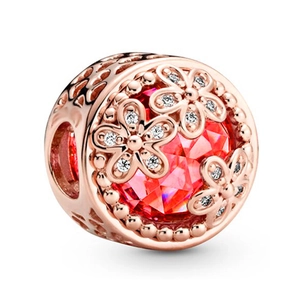 Rose gold flower charm with faceted red crystal and white zircon accents on white background